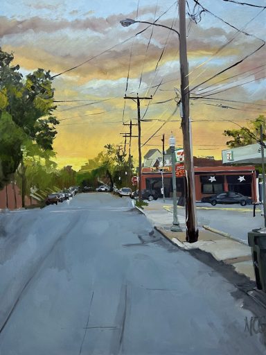 Yellow sunset over a city street with row houses, parallel parked cars, a bar and a gas station